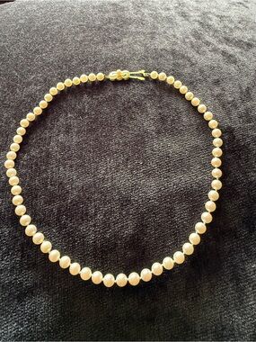 MIKIMOTO 16 in pearl necklace with 18 k gold clasp with centered signature pearl